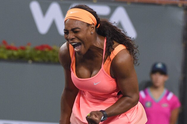 Serena Williams reacts after acing a serve to Monica Niculescu, of Romania, in a qualifying tennis match at the BNP Paribas Open tennis tournament, Tuesday, March 10, 2015, in Indian Wells, Calif. (AP Photo/Mark J. Terrill)