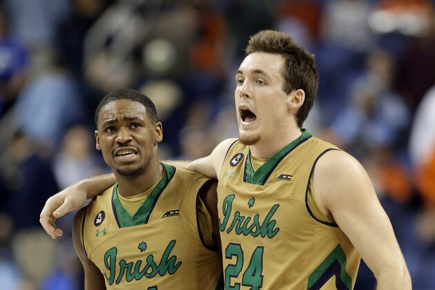 Notre Dame's Pat Connaughton (24) and Demetrius Jackson (11) celebrate after an NCAA college basketball game against Duke in the semifinals of the Atlantic Coast Conference tournament in Greensboro, N.C., Friday, March 13, 2015. Notre Dame won 74-64. (AP Photo/Bob Leverone)