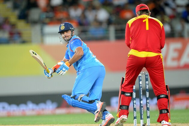 India's Suresh Raina plays a shot behind Zimbabwe wicketkeeper Brendon Taylor, right, during their Cricket World Cup Pool B match in Auckland, New Zealand, Saturday, March 14, 2015. (AP Photo/Ross Setford)