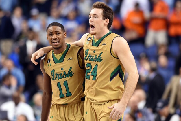 Mar 13, 2015; Greensboro, NC, USA; Notre Dame Fighting Irish guard Demetrius Jackson (11) and guard/forward Pat Connaughton (24) celebrate during game against the Duke Blue Devils in the second half during the semifinals of the ACC Tournament at Greensboro Coliseum. The Notre Dame Fighting Irish won 74-64. Mandatory Credit: Evan Pike-USA TODAY Sports