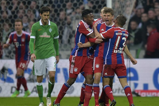 Bayern's Thomas Mueller, second right, celebrates after scoring the opening goal during the German Bundesliga soccer match between Werder Bremen and Bayern Munich in Bremen, Germany, Saturday, March 14, 2015. (AP Photo/Martin Meissner)