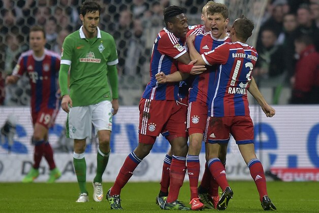 Bayern's Thomas Mueller, second right, celebrates after scoring the opening goal during the German Bundesliga soccer match between Werder Bremen and Bayern Munich in Bremen, Germany, Saturday, March 14, 2015. (AP Photo/Martin Meissner)