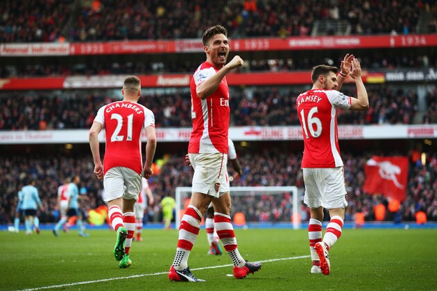 LONDON, ENGLAND - MARCH 14:  Olivier Giroud of Arsenal celebrates after the second Arsenal goal scored by Aaron Ramsey during the Barclays Premier League match between Arsenal and West Ham United at Emirates Stadium on March 14, 2015 in London, England.  (Photo by Ian Walton/Getty Images)