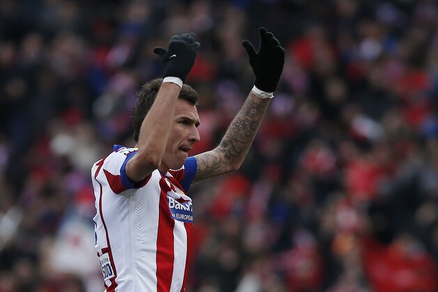 Atletico's Mario Mandzukic celebrates his goal during a Spanish La Liga soccer match between Atletico Madrid and Real Madrid at the Vicente Calderon stadium in Madrid, Spain, Saturday, Feb. 7, 2015. (AP Photo/Andres Kudacki)