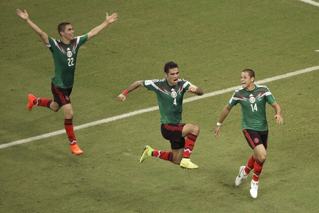 Mexico's Rafael Marquez  (4) celebrates scoring his side's first goal during the group A World Cup soccer match between Croatia and Mexico at the Arena Pernambuco in Recife, Brazil, Monday, June 23, 2014. (AP Photo/Hassan Ammar)