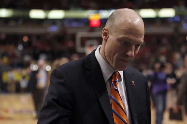 Illinois head coach John Groce walks off the court after an NCAA college basketball game against Michigan in the second round of the Big Ten Conference tournament, Thursday, March 12, 2015, in Chicago. Michigan won 73-55. (AP Photo/Kiichiro Sato)