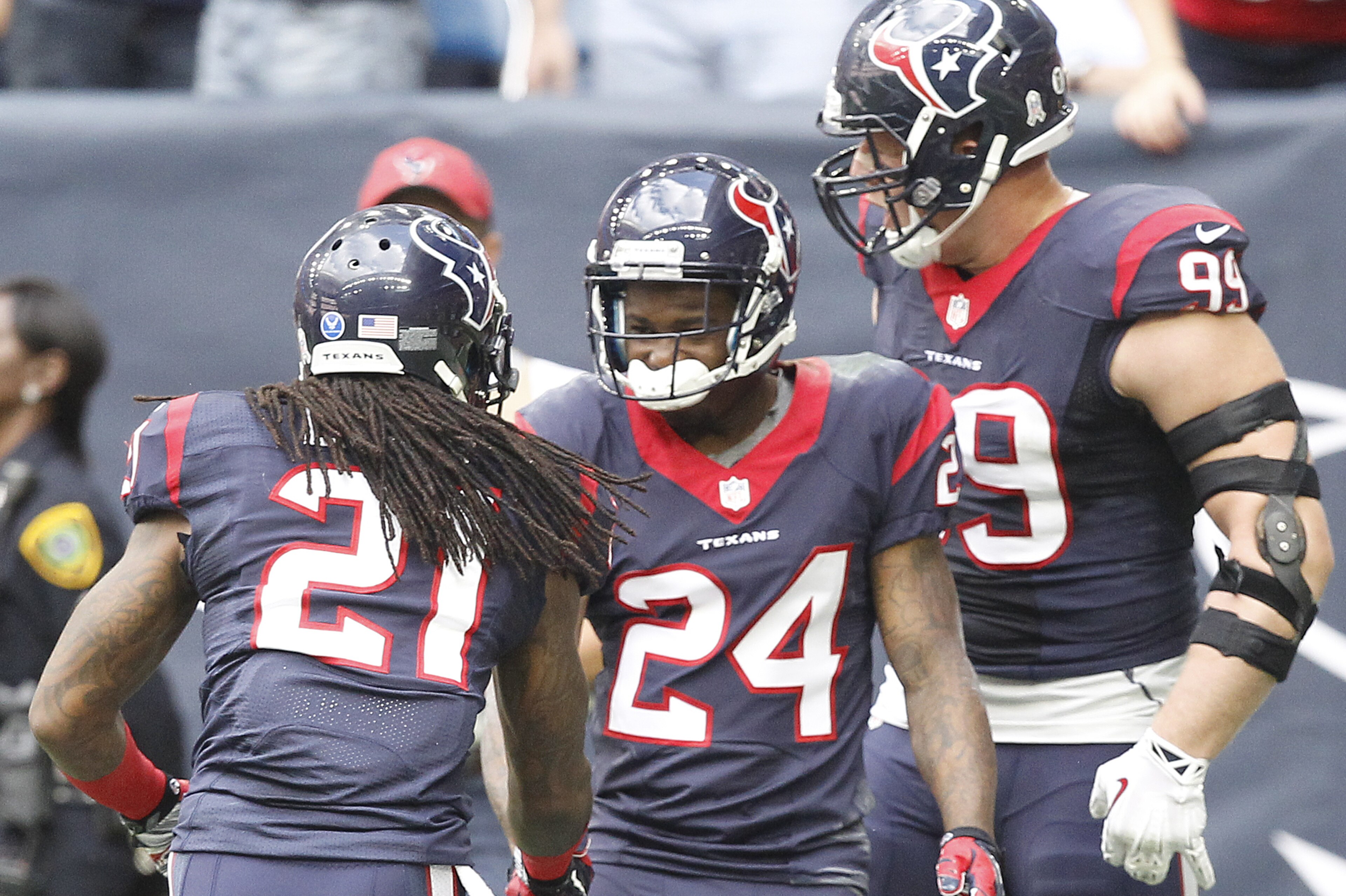 HOUSTON, TX - NOVEMBER 30: Johnathan Joseph #24 celebrates his interception with teammates Kendrick Lewis #21and J.J. Watt #99 of the Houston Texans against the Tennessee Titans in the first quarter in a NFL game on November 30, 2014 at NRG Stadium in Houston, Texas. (Photo by Bob Levey/Getty Images)