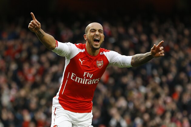 Arsenal's Theo Walcott celebrates scoring a goal during the English Premier League soccer match between Arsenal and Aston Villa at the Emirates stadium in London, Sunday, Feb. 1, 2015. (AP Photo/Kirsty Wigglesworth)