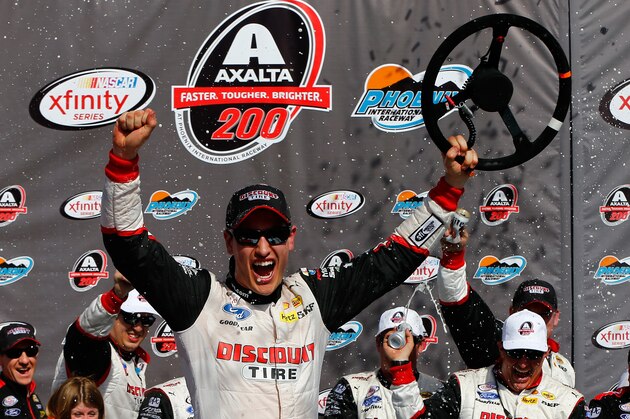AVONDALE, AZ - MARCH 14:  Joey Logano, driver of the #22 Discount Tire Ford, celebrates in victory lane after winning the NASCAR XFINITY Series Axalta Faster. Tougher. Brighter. 200 at Phoenix International Raceway on March 14, 2015 in Avondale, Arizona.  (Photo by Jonathan Ferrey/Getty Images)