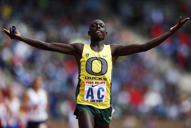 Oregon's Edward Cheserek raises his hands after crossing the finish line during the College Men's Distance Medley Championship of America at the Penn Relays athletics meet, Friday, April 25, 2014, in Philadelphia. Oregon won with a time of 9:25.40. (AP Photo/Matt Rourke)