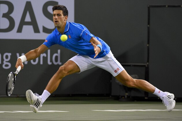 Novak Djokovic, of Serbia, returns to Marcos Baghdatis, of Cyprus, during their match at the BNP Paribas Open tennis tournament, Saturday, March 14, 2015, in Indian Wells, Calif. (AP Photo/Mark J. Terrill)