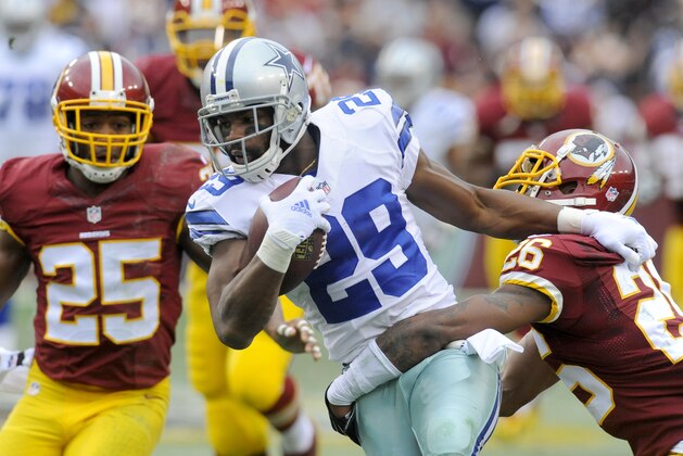 Dallas Cowboys running back DeMarco Murray (29) is stopped by Washington Redskins cornerback Bashaud Breeland (26) during the first half of an NFL football game in Landover, Md., Sunday, Dec. 28, 2014. Murray set the franchise single-season rushing record for the Cowboys on the play. (AP Photo/Richard Lipski)