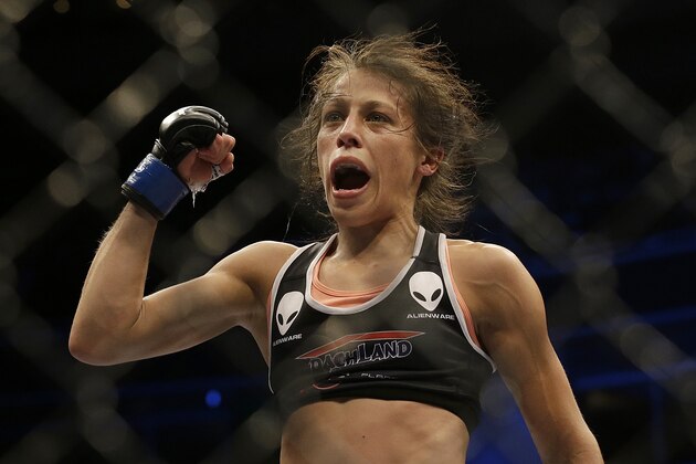 Joanna Jedrzejczyk celebrates after beating Juliana Lima by unanimous decision in a women's strawweight mixed martial arts bout at a UFC on Fox event in San Jose, Calif., Saturday, July 26, 2014. (AP Photo/Jeff Chiu)