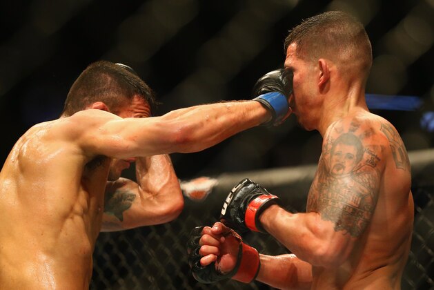 DALLAS, TX - MARCH 14:  (L-R) Rafael dos Anjos fights with Anthony Pettis in the Lightweight Title bout during the UFC 185 event at American Airlines Center on March 14, 2015 in Dallas, Texas.  (Photo by Ronald Martinez/Getty Images)