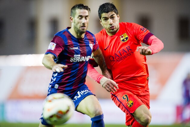 EIBAR, SPAIN - MARCH 14:  Luis Suarez of FC Barcelona duels for the ball with Manuel Castellano ÔLillo' of SD Eibar during the La Liga match between SD Eibar and FC Barcelona at Ipurua Municipal Stadium on March 14, 2015 in Eibar, Spain.  (Photo by Juan Manuel Serrano Arce/Getty Images)