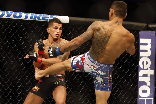 Mar 14, 2015; Dallas, TX, USA; Anthony Pettis (red) fights Rafael dos Anjos (blue) in the lightweight title bout during UFC 185 at American Airlines Center. Mandatory Credit: Tim Heitman-USA TODAY Sports