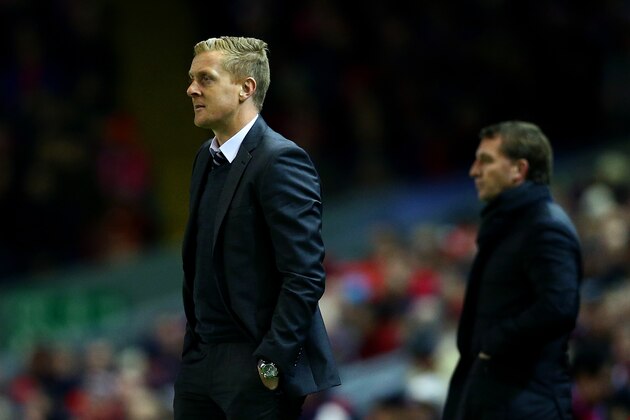 LIVERPOOL, ENGLAND - DECEMBER 29:  Manager Garry Monk of Swansea City looks on next to Brendan Rodgers, manager of Liverpool during the Barclays Premier League match between Liverpool and Swansea City at Anfield on December 29, 2014 in Liverpool, England.  (Photo by Clive Brunskill/Getty Images)