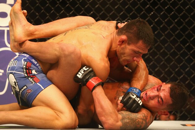 DALLAS, TX - MARCH 14:  Rafael dos Anjos, top fights with Anthony Pettis in the Lightweight Title bout during the UFC 185 event at American Airlines Center on March 14, 2015 in Dallas, Texas.  (Photo by Ronald Martinez/Getty Images)