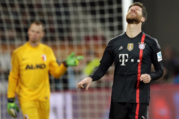 Bayern’s Xabi Alonso from Spain reacts during the German first division Bundesliga soccer match between FC Augsburg and FC Bayern Munich in the SGL Arena in Augsburg, Germany, on Saturday, Dec. 13, 2014. (AP Photo/Matthias Schrader)