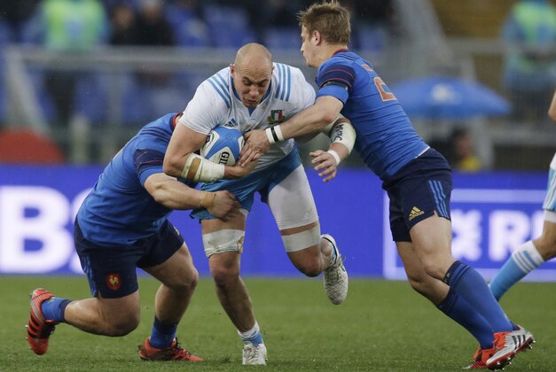 Italy’s Sergio Parisse, center, is tackled by France’s Vincent Debaty, left, and Jules Plisson during a Six Nations rugby union match between Italy and France, at Rome's Olympic Stadium, Sunday, March 15, 2015. (AP Photo/Andrew Medichini)