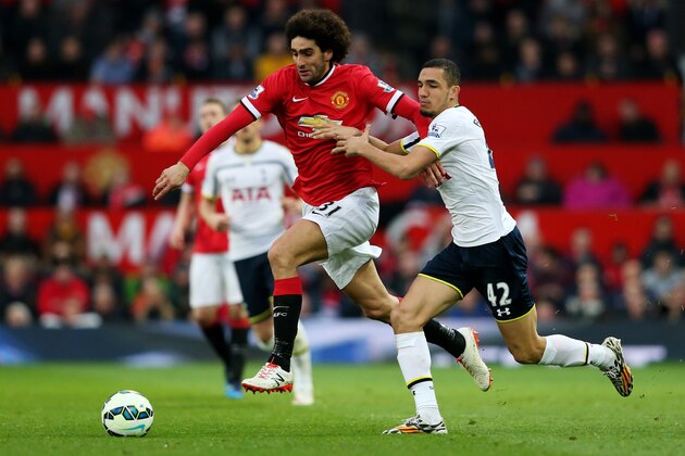 MANCHESTER, ENGLAND - MARCH 15:  Marouane Fellaini of Manchester United is challenged by Nabil Bentaleb of Spurs during the Barclays Premier League match between Manchester United and Tottenham Hotspur at Old Trafford on March 15, 2015 in Manchester, England.  (Photo by Alex Livesey/Getty Images)
