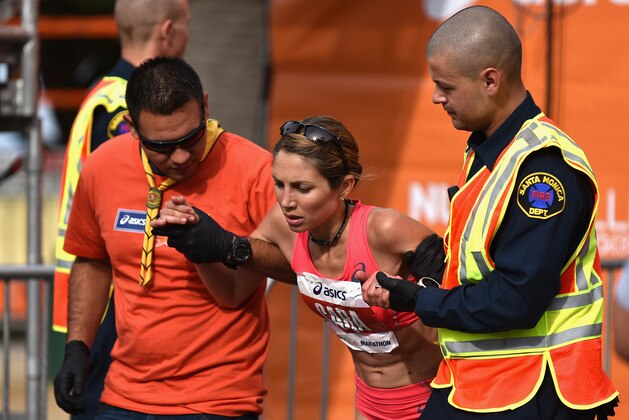 LOS ANGELES, CA - MARCH 15:   ASICS Elite Athlete Sara Hall is assisted by first aid after finishing the 2015 ASICS LA Marathon on March 15, 2015 in Los Angeles, California.  (Photo by Jonathan Moore/Getty Images)