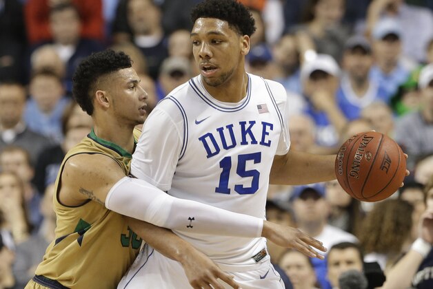 Duke's Jahlil Okafor, right, drives against Notre Dame's Zach Auguste, left, during the first half of an NCAA college basketball game in the semifinals of the Atlantic Coast Conference tournament in Greensboro, N.C., Friday, March 13, 2015. (AP Photo/Gerry Broome)