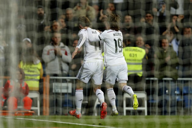 Real Madrid's Gareth Bale, left, is followed by Real Madrid's Luka Modric as he celebrates after scoring a goal during a Spanish La Liga soccer match between Real Madrid and Levante at the Santiago Bernabeu stadium in Madrid, Spain, Sunday, March 15, 2015. (AP Photo/Daniel Ochoa de Olza)