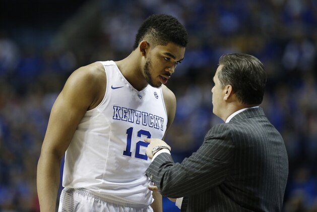 Kentucky forward Karl-Anthony Towns (12) speaks to Kentucky head coach John Calipari during the second half of the NCAA college basketball Southeastern Conference tournament championship game against Arkansas, Sunday, March 15, 2015, in Nashville, Tenn. (AP Photo/Steve Helber)