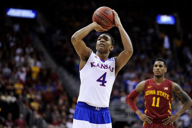KANSAS CITY, MO - MARCH 14:  Devonte Graham #4 of the Kansas Jayhawks shoots a free throw against the Iowa State Cyclones in the second half during the championship game of the Big 12 Basketball Tournament at Sprint Center on March 14, 2015 in Kansas City, Missouri.  (Photo by Ed Zurga/Getty Images)
