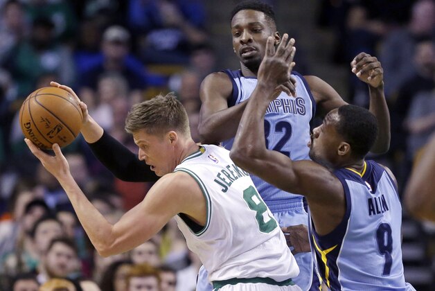 Boston Celtics forward Jonas Jerebko (8) moves with the ball away from the defense of Memphis Grizzlies forwards Jeff Green (32) and Tony Allen (9) during the first half of an NBA basketball game in Boston, Wednesday, March 11, 2015. (AP Photo/Elise Amendola)