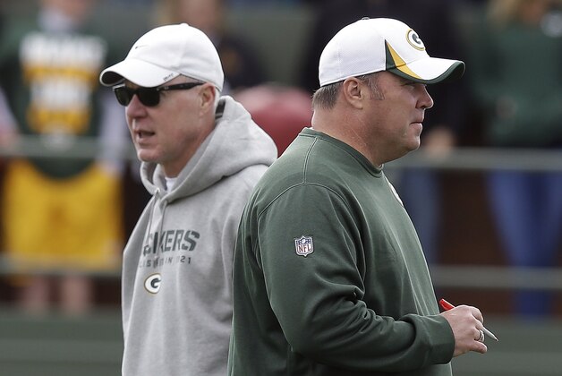 Green Bay Packers head coach Mike McCarthy talks to general manager Ted Thompson during NFL football training camp Sunday, July 28, 2013, in Green Bay, Wis. (AP Photo/Morry Gash)