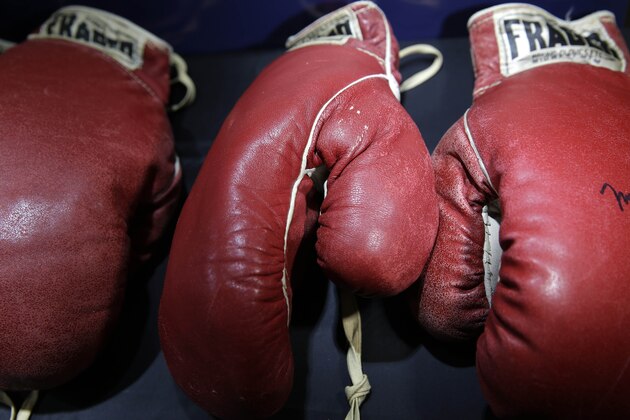 Boxing gloves worn by Muhammad Ali and Sonny Liston are displayed in New York, Thursday, Feb. 19, 2015. Just months before the 50th anniversary of the heavyweight rematch between Ali and Liston, boxing fans are getting a chance to own a piece of one of the most hotly debated title fights of all time. Both pairs of gloves from the May 25, 1965, bout in Lewiston, Maine — won by Ali with a first-round knockout from what some saw as a