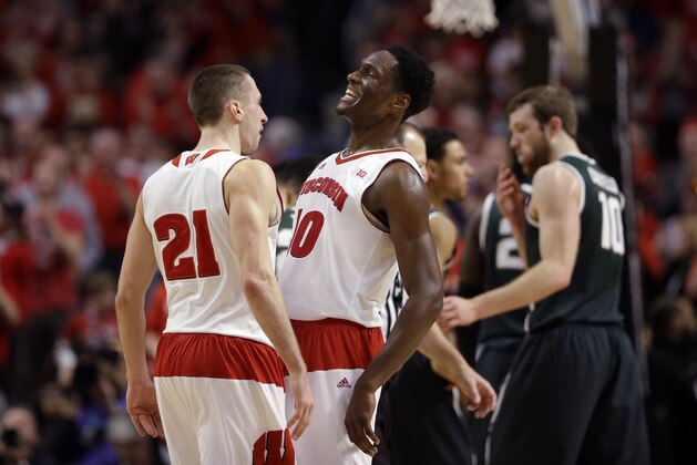 Wisconsin's Josh Gasser (21) and  Nigel Hayes (10) celebrates in the in the overtime period of an NCAA college basketball game against Michigan State  in the championship of the Big Ten Conference tournament in Chicago, Sunday, March 15, 2015.  Wisconsin defeated Michigan State 80-69 in overtime.  (AP Photo/Michael Conroy)