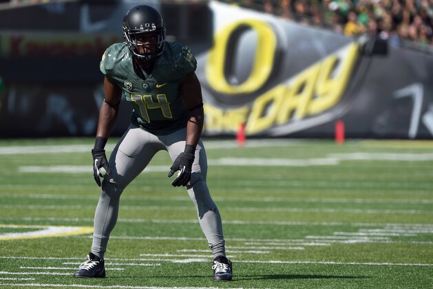 Oregon Ducks defensive back Ifo Ekpre-Olomu (14) gets set at the line of scrimmage during the third quarter of the college football game against the Wyoming at Autzen Stadium on Saturday, Sept. 13, 2014 in Eugene, Ore. (AP Photo/Steve Dykes)