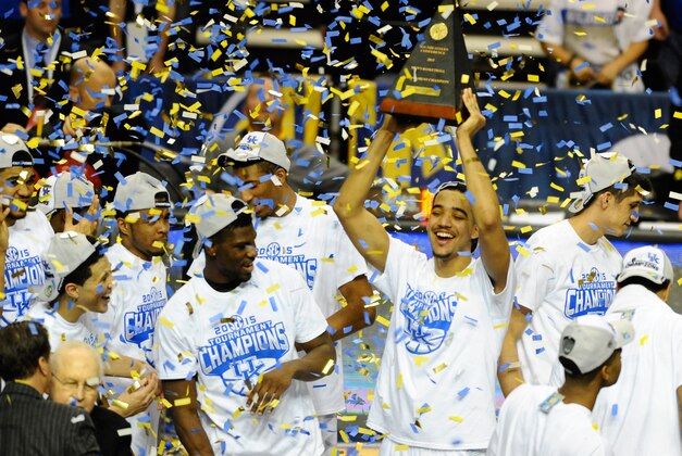 Mar 15, 2015; Nashville, TN, USA; Kentucky Wildcats players celebrate with the championship trophy after winning the SEC Conference Championship game against the Arkansas Razorbacks at Bridgestone Arena. Kentucky won 78-63. Mandatory Credit: Christopher Hanewinckel-USA TODAY Sports