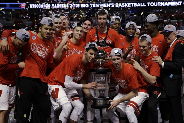 Wisconsin celebrates with the trophy after winning the Big Ten tournament in an NCAA college basketball game in Chicago, Sunday, March 15, 2015.  Wisconsin defeated Michigan State 80-69 in overtime.  (AP Photo/Nam Y. Huh)