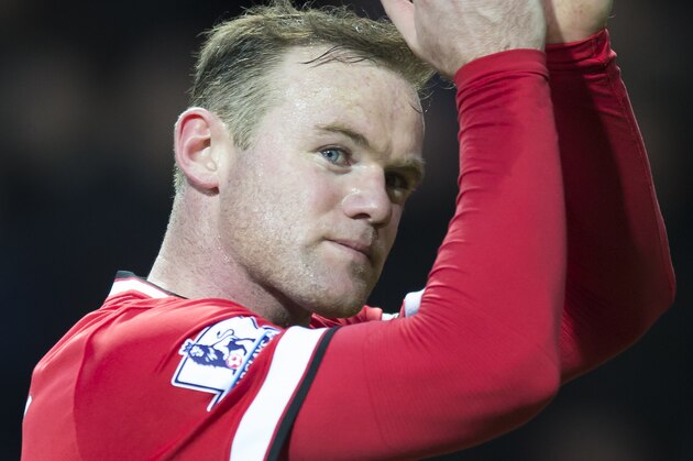 Manchester United's Wayne Rooney applauds supporters after the English Premier League soccer match between Manchester United and Tottenham Hotspur at Old Trafford Stadium, Manchester, England, Sunday March 15, 2015. (AP Photo/Jon Super)
