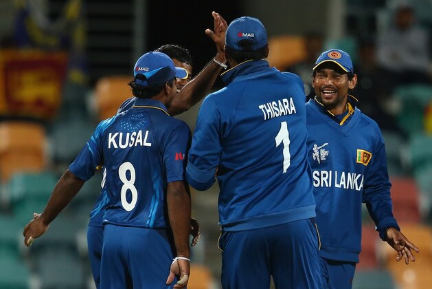 HOBART, AUSTRALIA - MARCH 11:  Sri Lankan team celebrate the wicket of Michael Leask of Scotland during the 2015 Cricket World Cup match between Sri Lanka and Scotland at Bellerive Oval on March 11, 2015 in Hobart, Australia.  (Photo by Mark Kolbe/Getty Images)