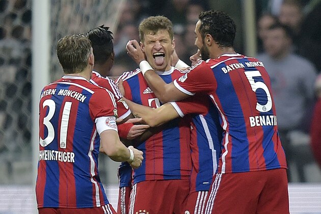 Bayern's Thomas Mueller, center, celebrates after scoring the opening goal  during the German Bundesliga soccer match between Werder Bremen and Bayern Munich in Bremen,  Germany, Saturday, March 14, 2015. (AP Photo/Martin Meissner)