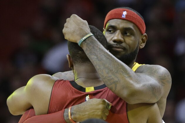 Cleveland Cavaliers forward LeBron James, right, hugs Miami Heat guard Dwyane Wade before an NBA basketball game, Thursday, Dec. 25, 2014, in Miami. (AP Photo/Lynne Sladky)