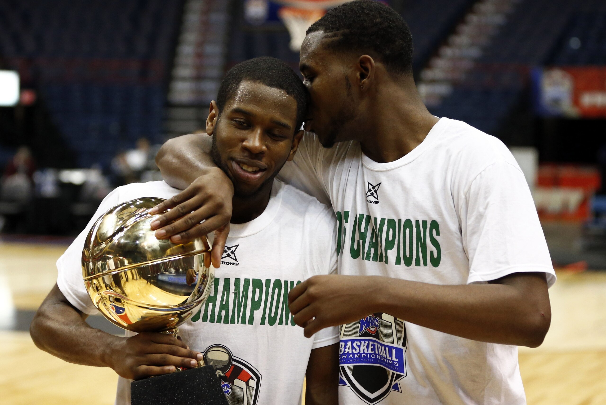Mar 9, 2015; Albany, NY, USA; Manhattan Jaspers guard Donovan Kates (right) and guard Tyler Wilson (left) celebrate with the championship trophy after defeating the Iona Gaels in the championship game of the MAAC Conference Tournament at Times Union Center. Mandatory Credit: Mark L. Baer-USA TODAY Sports