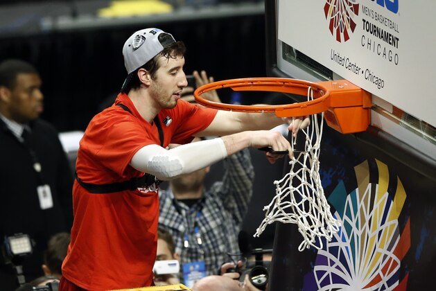 Wisconsin's Frank Kaminsky (44) cuts the net after winning an NCAA college basketball game in the championship of the Big Ten Conference tournament in Chicago, Sunday, March 15, 2015.  Wisconsin defeated Michigan State 80-69 in overtime. (AP Photo/Kamil Krzaczynski)