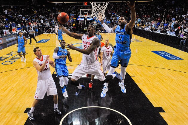 NEW YORK, NY - MARCH 14: Jordan Sibert #24 of the Dayton Flyers attempts a shot under Hassan Martin #12 of the Rhode Island Rams during a semifinal game in the 2015 Men's Atlantic 10 Basketball Tournament at the Barclays Center on March 14, 2015 in the Brooklyn borough of New York City.  (Photo by Alex Goodlett/Getty Images)