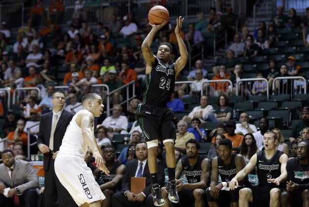 Green Bay guard Keifer Sykes (24) shoots over Miami guard Angel Rodriguez in the second half of an NCAA college basketball game, Saturday, Dec. 6, 2014, in Coral Gables, Fla. Green Bay defeated Miami 68-55. (AP Photo/Lynne Sladky)