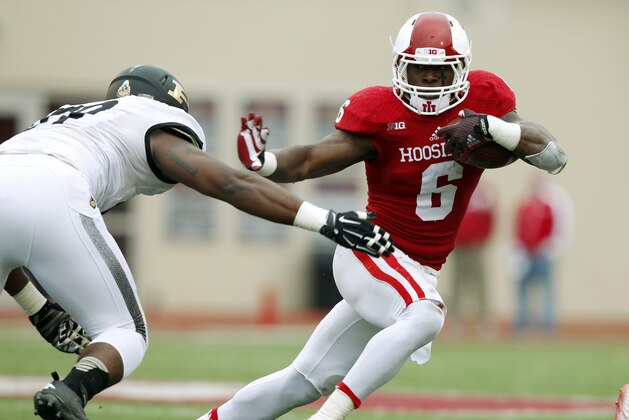 Indiana running back Tevin Coleman (6) fights to break free from Purdue's Jalani Phillips (89) during the second half of an NCAA college football game at Memorial Stadium in Bloomington, Ind., Saturday, Nov. 29, 2014.    (AP Photo/John Sommers II)
