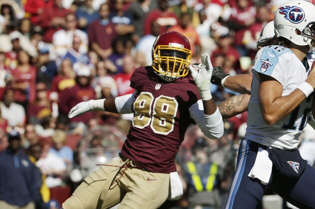 Washington Redskins linebacker Brian Orakpo (98) goes after Tennessee Titans quarterback Charlie Whitehurst (12) but is covered by Taylor Lewan (77) during the second half of a NFL football game Sunday, Oct. 19, 2014. at Fedex Field in Landover, MD. (AP Photo/Pablo Martinez Monsivais)