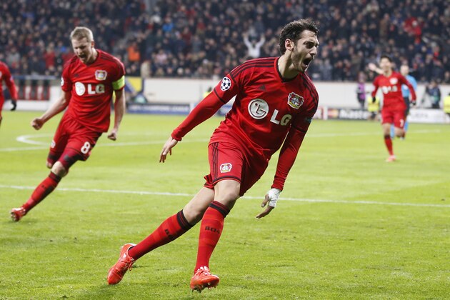Leverkusen's Hakan Calhanoglu celebrates after scoring the opening goal during the Champions League round of 16 first leg soccer match between Bayer 04 Leverkusen and Atletico de Madrid on Wednesday, Feb. 25, 2015 in Leverkusen, Germany. (AP Photo/Frank Augstein)