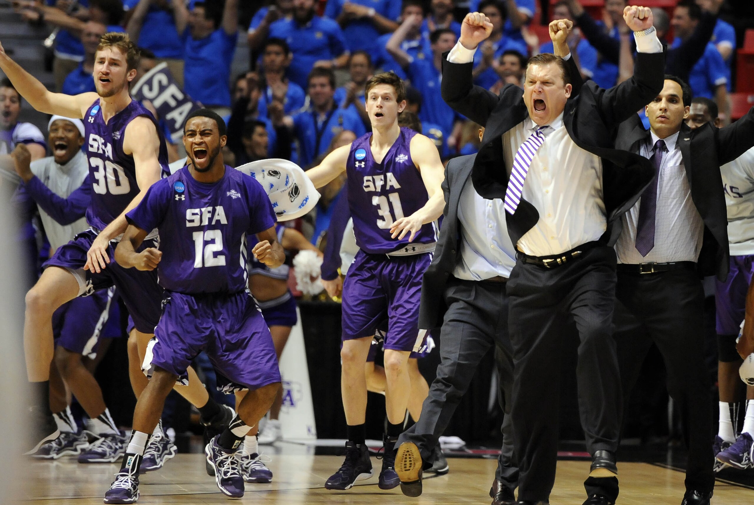 Mar 21, 2014; San Diego, CA, USA; Stephen F. Austin Lumberjacks head coach Danny Kaspar celebrates with his players after defeating the VCU Rams in a men's college basketball game during the second round of the 2014 NCAA Tournament at Viejas Arena. Mandatory Credit: Christopher Hanewinckel-USA TODAY Sports