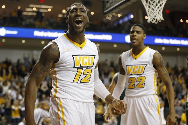Mar 7, 2015; Richmond, VA, USA; Virginia Commonwealth Rams forward Mo Alie-Cox (12) celebrates as Rams guard/forward Terry Larrier (22) looks on against the George Mason Patriots in the first half at Stuart Siegel Center. The Rams won 71-60. Mandatory Credit: Geoff Burke-USA TODAY Sports